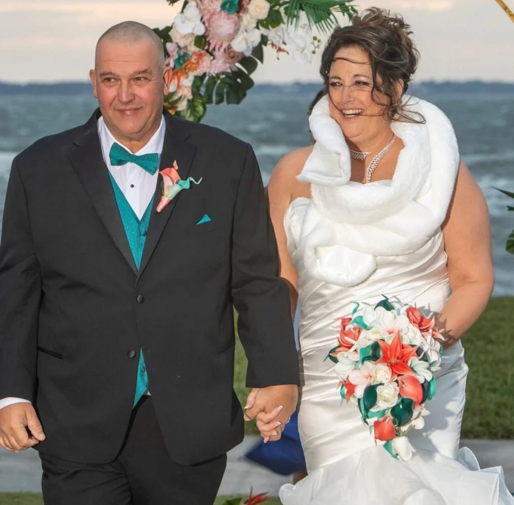 Couple holding hands at a beach wedding ceremony in Jacksonville, FL